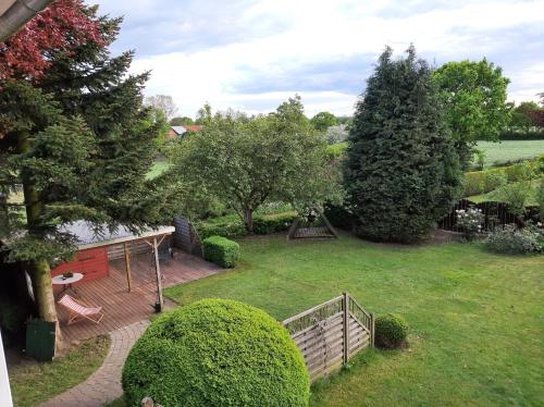 a view of a yard with a fence and trees at Hütti's Hütte in Oldendorf