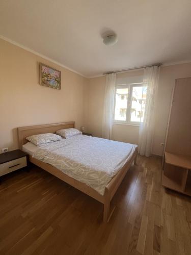 a bedroom with a bed and a window at Lido MONTENEGRO Bijela in Bijela