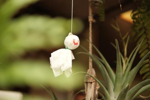 a paper monkey hanging from a plant at Abrakadabra Manshon in Timuran