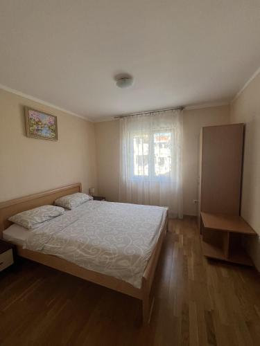 a bedroom with a bed and a window at Lido MONTENEGRO Bijela in Bijela