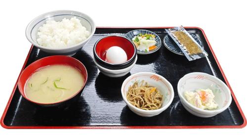a tray with bowls of food on a table at Toyoko Inn Kumamoto Airport in Ozu