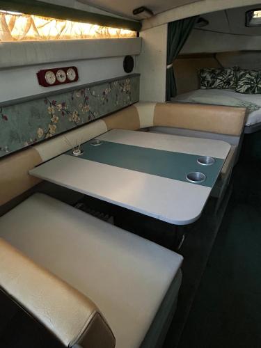 a room with two beds and a table in it at barco marismas del sur in Punta Umbría