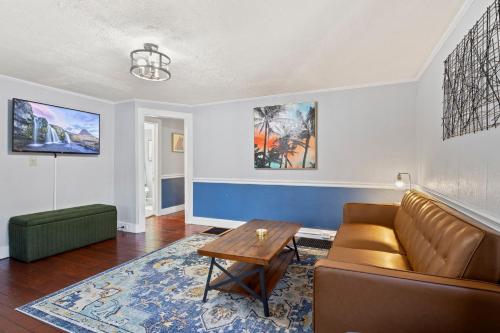 a living room with a couch and a table at Hot Tub! Close to Cornell, Ithaca College, Commons! in Ithaca