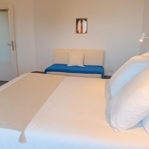 a bedroom with a large bed and a couch at Appartement de charme à Digoin #14 in Digoin