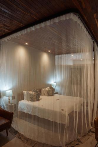 a bedroom with a bed through a window at Chobe River Lodge in Kasane
