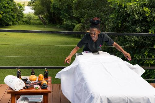 a woman standing on top of a table at Chobe River Lodge in Kasane