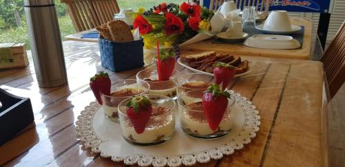 a table with several glasses of dessert with strawberries in them at Campo Del Mare in Sirolo