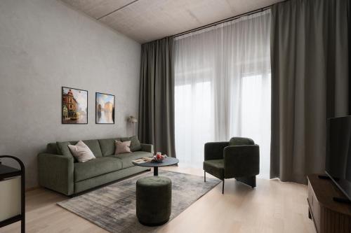 a living room with a couch and a chair at Vander Aparthotel Inre Hamnen in Norrköping
