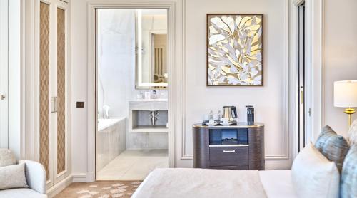 a hotel room with a bed and a bathroom at La Réserve de Beaulieu in Beaulieu-sur-Mer