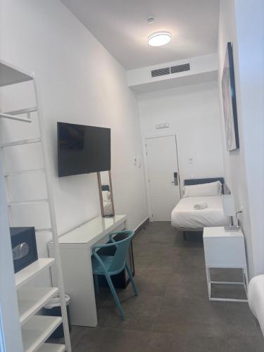 a small room with a bed and a desk and a bedroom at Hotel Kuve Marbella in Marbella