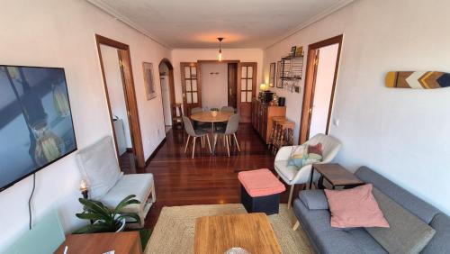 a living room with a couch and a table at Barquiña Beach House in the heart of San Vicente in San Vicente de la Barquera