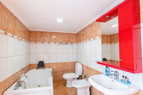 a bathroom with a white toilet and a sink at Roan Apartments in Sarandë