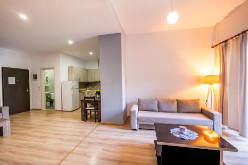 a living room with a couch and a table at Roan Apartments in Sarandë