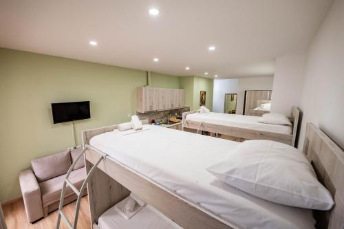 a hospital room with two beds and a tv at Roan Apartments in Sarandë