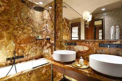 a bathroom with a sink and a mirror at Palazzo Venart Luxury Hotel in Venice