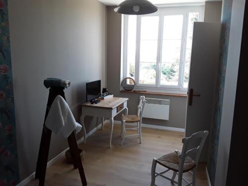 a room with a desk with a computer and a window at La Maison Bleue - La Belle Epoque in Rosières