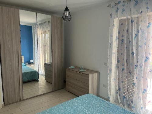 a bedroom with a mirror and a bed and a dresser at Flavio alloggio turistico in Fiumicino