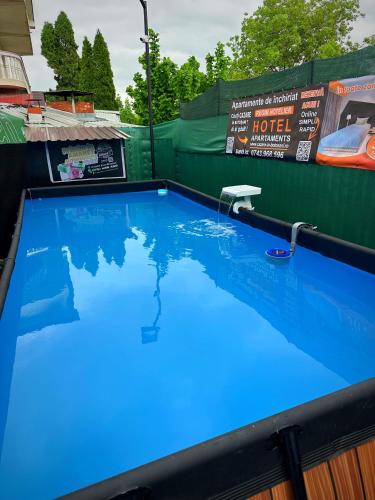 a swimming pool with blue water on top at Apartament 2 dormitoare LUX situat la parter in complex ApartHotel Botosani 3 in Botoşani