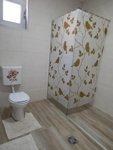 a bathroom with a toilet and a shower curtain at Andjela LUX in Belgrade