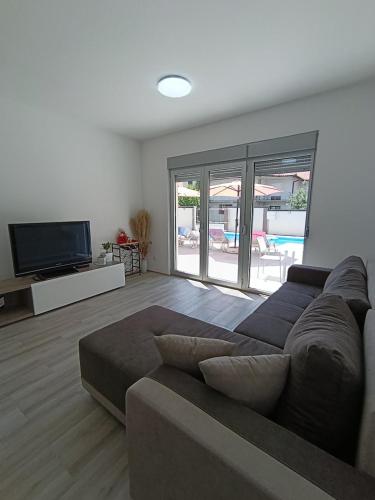 a living room with a couch and a flat screen tv at Andjela LUX in Belgrade