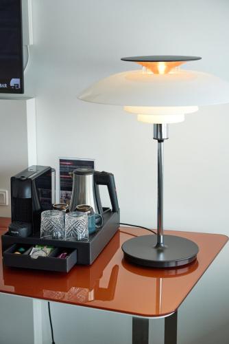 a table with a lamp and a tray of food at Hotel Hans Egede in Nuuk