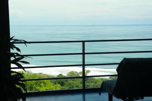 a view of the ocean from a balcony at Ranchos Remo Lodge in Uvita