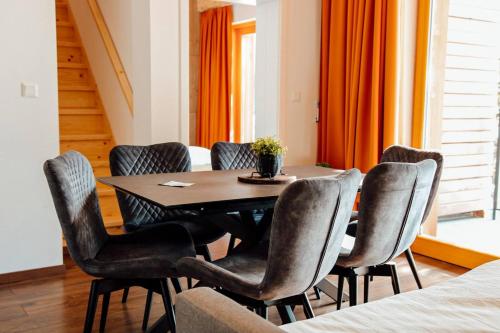 a dining room with a table and six chairs at Apartmán 31 - Villa Erdődy Resort in Oravská Lesná