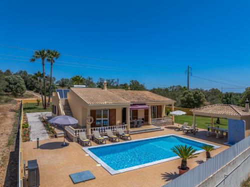 a home with a swimming pool and a house at Villa Monte Velho in Albufeira