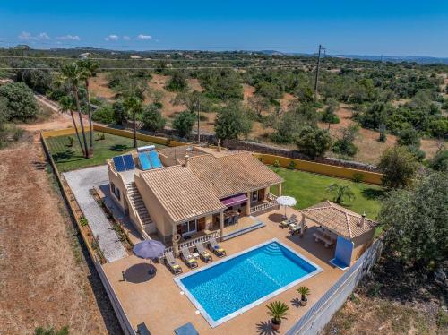 an aerial view of a house with a swimming pool at Villa Monte Velho in Albufeira