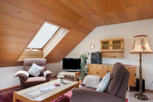 a living room with a table and chairs and a tv at Haus Marianne Dörflinger in Schluchsee