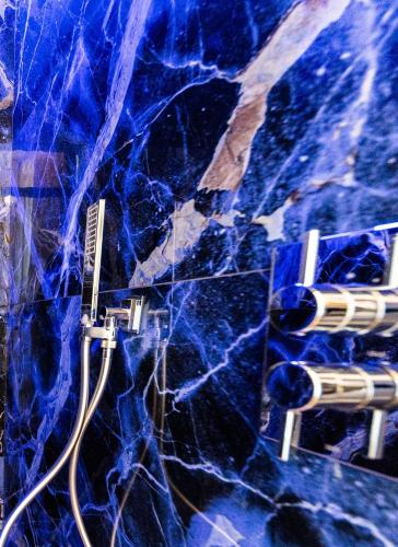 a blue marble counter top with a toothbrush in a shower at Ariccia Luxury House in Ariccia