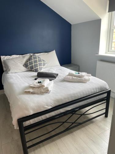 a bedroom with a bed with a blue wall at Newton house in Burton Fleming