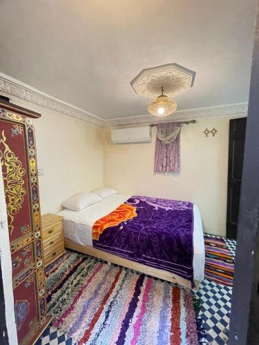 a bedroom with a bed and a dresser at Dar Atlantic in Fès