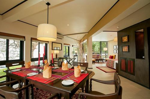 a dining room with a table and chairs at EKHO Safari Tissa in Tissamaharama