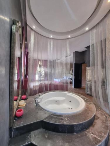 a large bathroom with a large tub in a room at Domaine Marradise in Marrakesh
