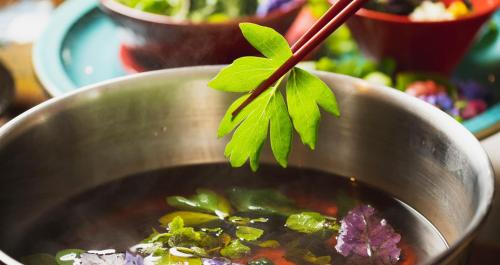 a metal bowl of soup with a plant in it at HOTEL SANSUI NAHA Ryukyu Onsen Naminoue-No-Yu in Naha