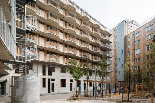 an apartment building in the middle of a city at Vander Aparthotel Inre Hamnen in Norrköping