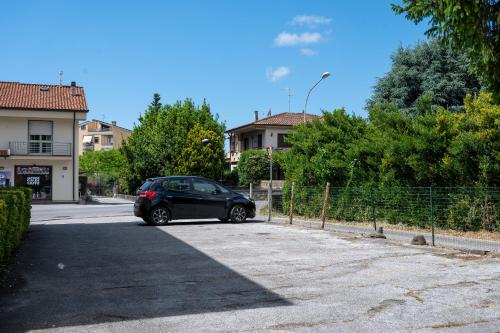 a black car parked in a parking lot at Hotel Marnie in Massarosa