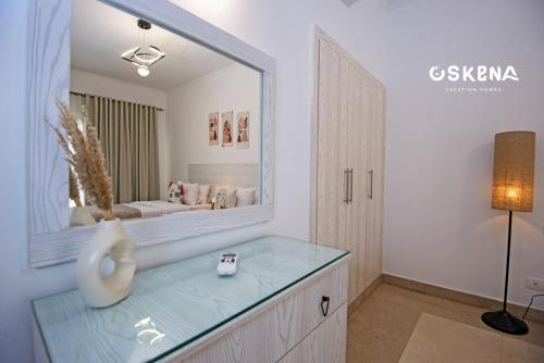 a bathroom with a large mirror on a dresser at OSKENA Azzurra Sahl Hasheesh Hurghada in Hurghada