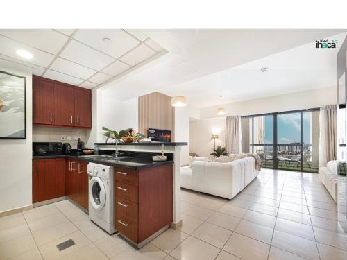 a kitchen and living room with a washer and dryer at Boho Studio Beachfront Ain Sea View JBR Walk 1min in Dubai