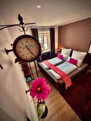 a room with a clock on the wall and a couch at Three Rivers 3 in Passau