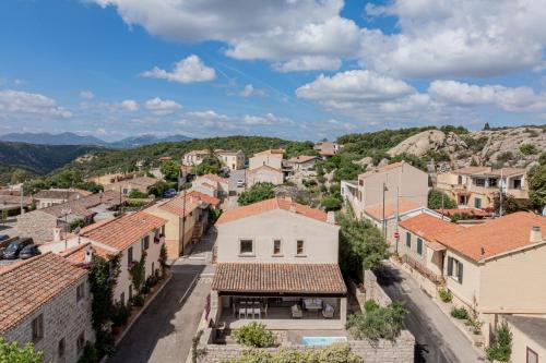 a view of a town with mountains in the background at Villa dell'800 con Jacuzzi Privata - San Pantaleo in San Pantaleo