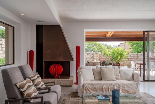 a living room with a couch and a fireplace at Villa dell'800 con Jacuzzi Privata - San Pantaleo in San Pantaleo