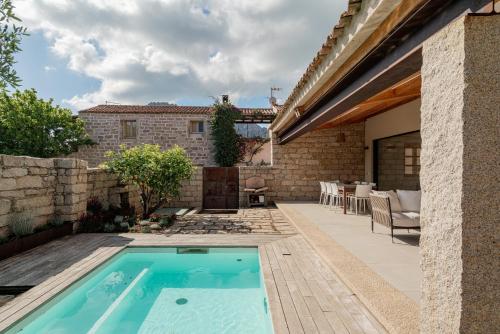 a swimming pool in the backyard of a house at Villa dell'800 con Jacuzzi Privata - San Pantaleo in San Pantaleo