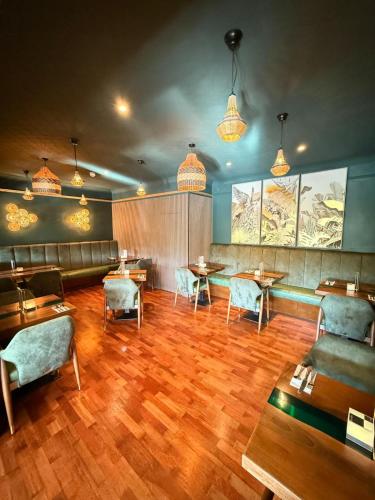 a restaurant with wooden floors and tables and chairs at Craigvrack Hotel & Restaurant in Pitlochry