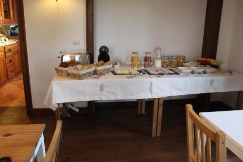 a table with a white table cloth and food on it at Casa do Marco in Sintra