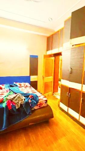 a bedroom with a bed in a room with wooden floors at Ridge Lakkar Stay in Shimla
