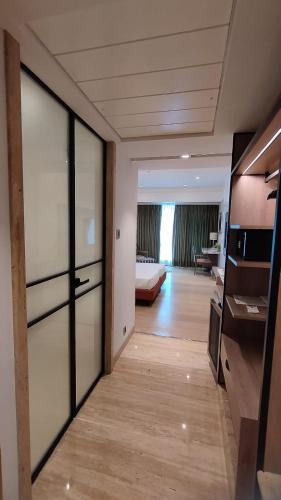 a room with a sliding glass door with a bedroom at Mirage Hotel, Mumbai International Airport in Mumbai