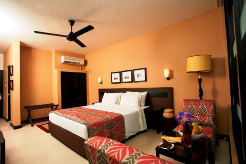 a hotel room with a bed and a couch at EKHO Safari Tissa in Tissamaharama