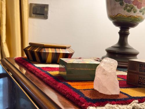 a table with a candle and a box on a table at La casa nel Bosco in Manziana